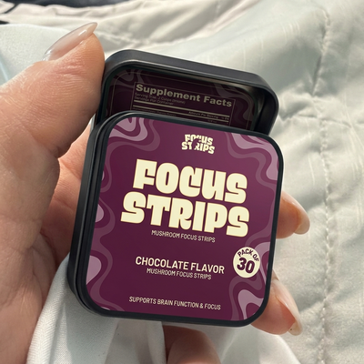CogniStrips customer holding a tin of Focus Strips