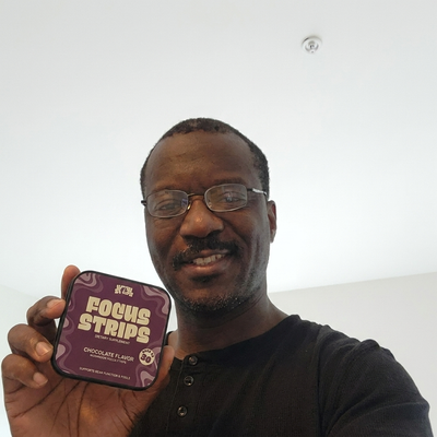 CogniStrips customer holding a tin of Focus Strips